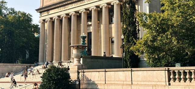 Studierende sitzen auf den Stufen vor der historischen Bibliothek der Columbia University in New York, wie sie viele Fulbright-Stipendiat*innen in den USA erleben.