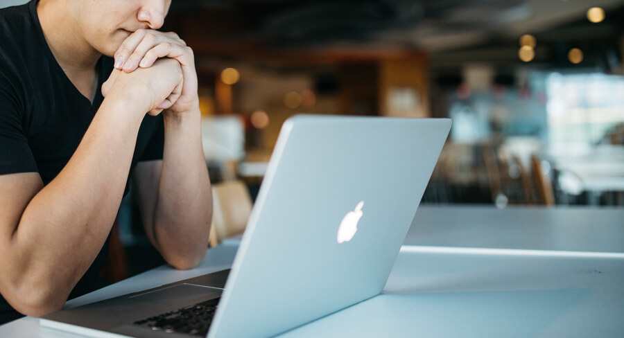 Male student looks at his laptop