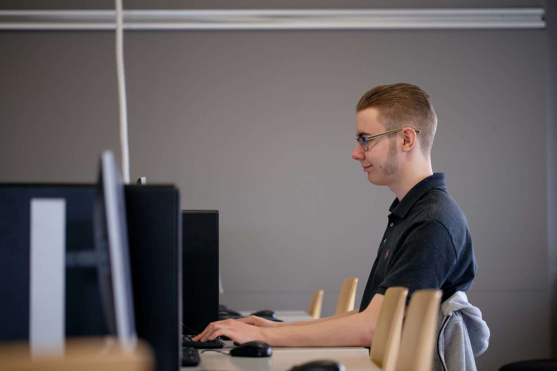Student sitting by computer.