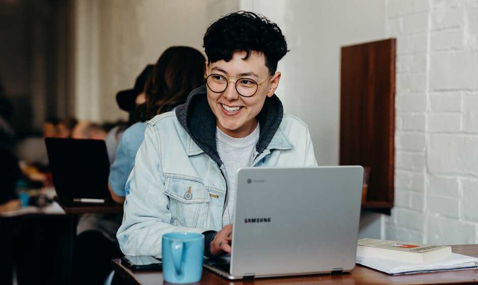 Student laughing with laptop