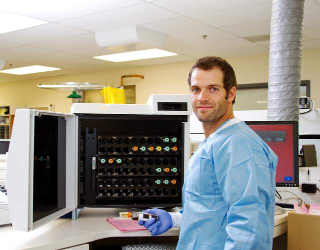 Laboratory technician in hospital with blood culture specimen