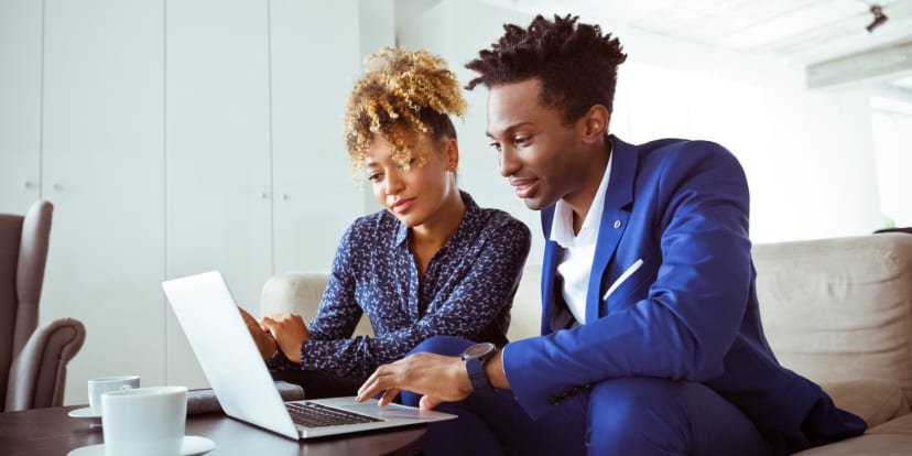 MBA students looking at a laptop