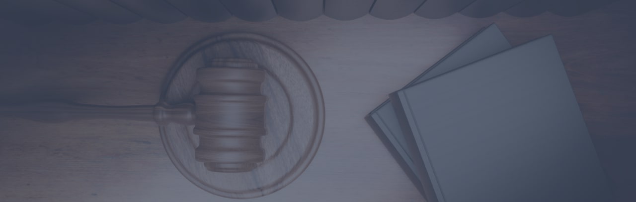 Legal books and judge gavel on wooden desk