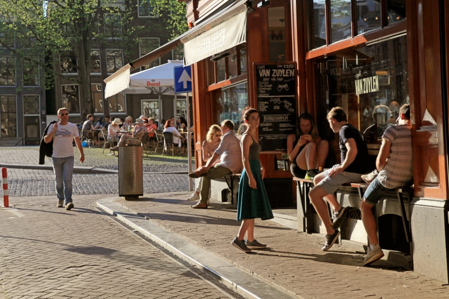 Young people in outdoor cafÃ© in historic center of Amsterdam