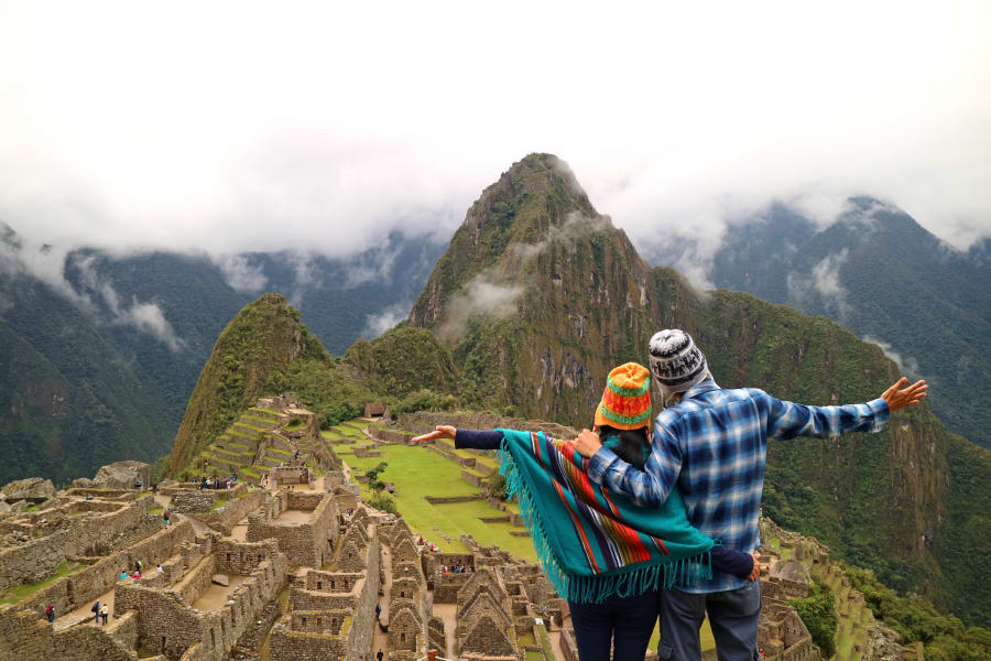 Couple admiring the spectacular view of Machu Picchu, Cusco Region, Urubamba Province, Peru, Archaeological site, UNESCO World Heritage