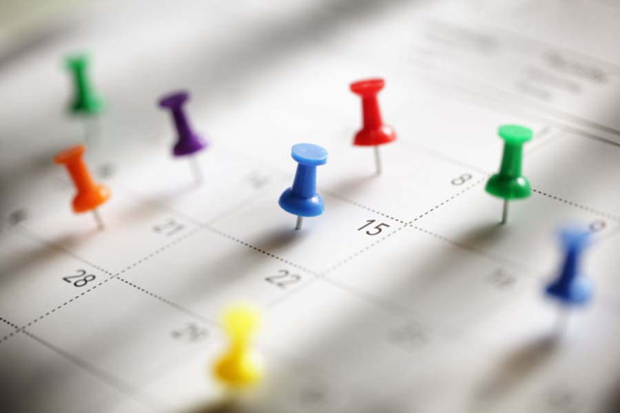 Thumbtack in calendar concept for busy, appointment and meeting reminder
