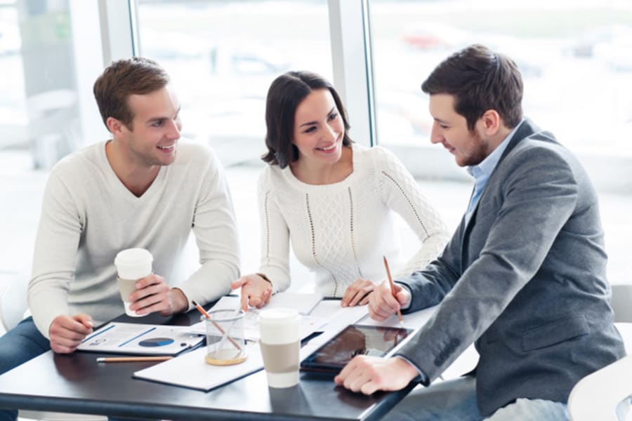 Cheerful colleagues discussing project