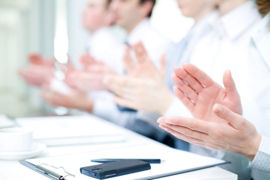 Photo of business partners hands applauding at meeting