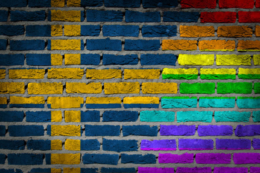 Dark brick wall texture - coutry flag and rainbow flag painted on wall - Sweden