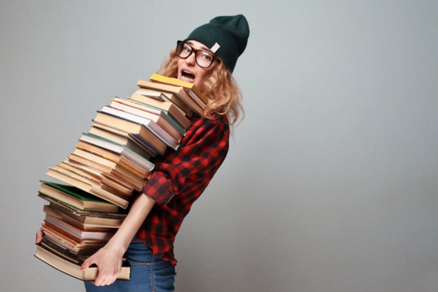 stylish nerd girl with many books