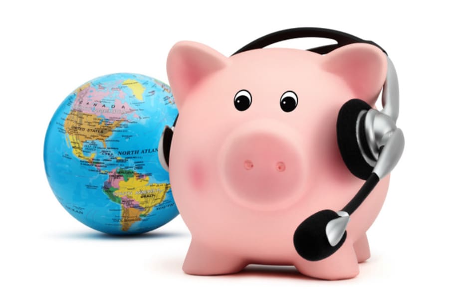 piggy bank with headset and globe isolated on white backround