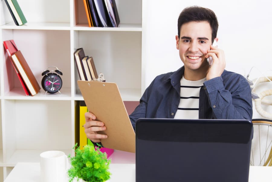 man talking by phone mobile in front of the computer in the office or house