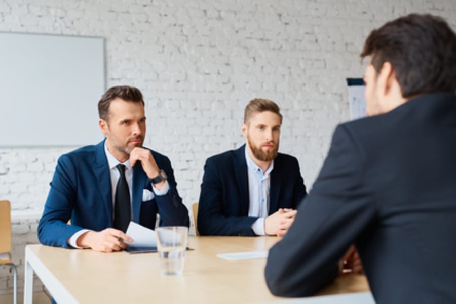 Job interview - two business man recruit candidate at their office