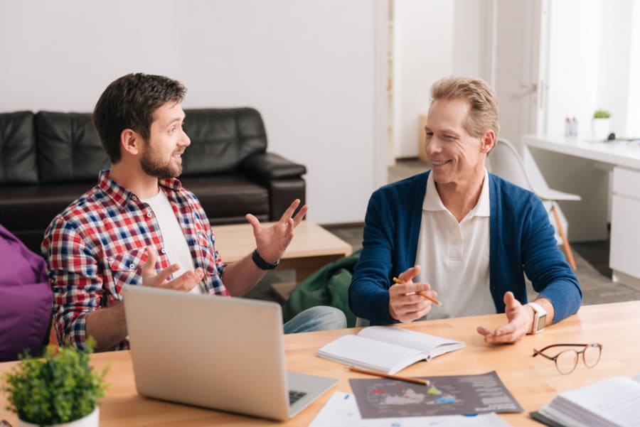 Cheerful good looking men having a conversation