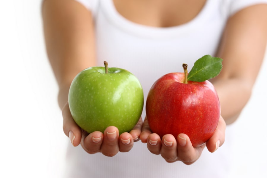 Hands holding red and green apples