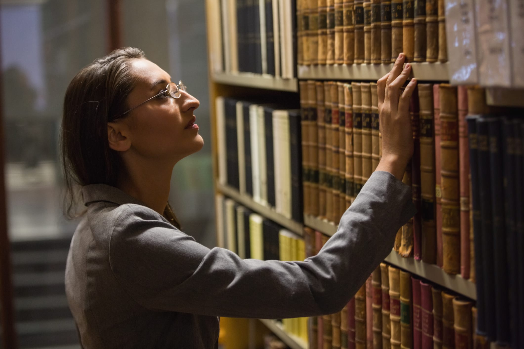 Lawyer picking book in the law library