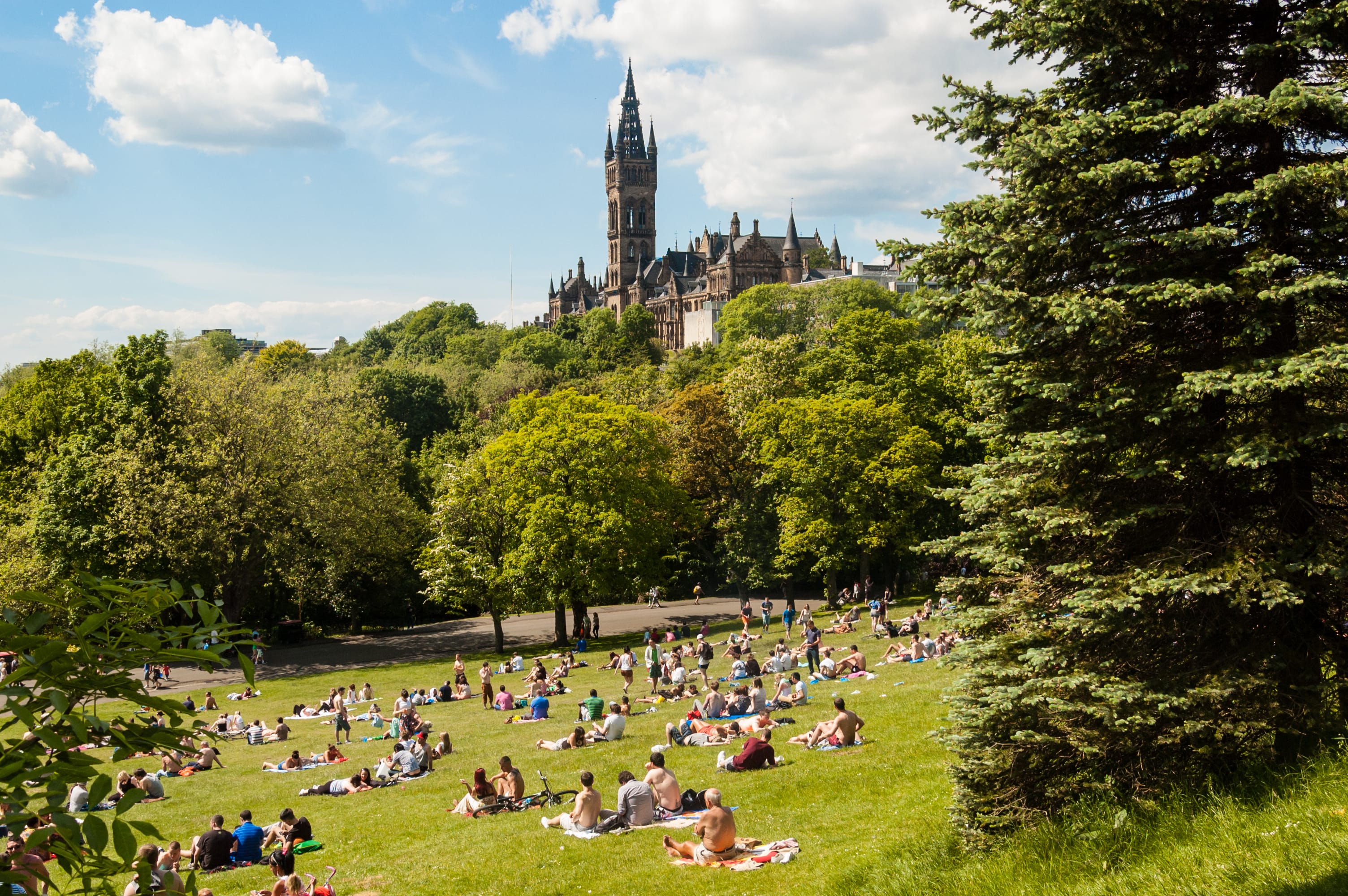 View of Kelvingrove Park with people and the Glasgow University