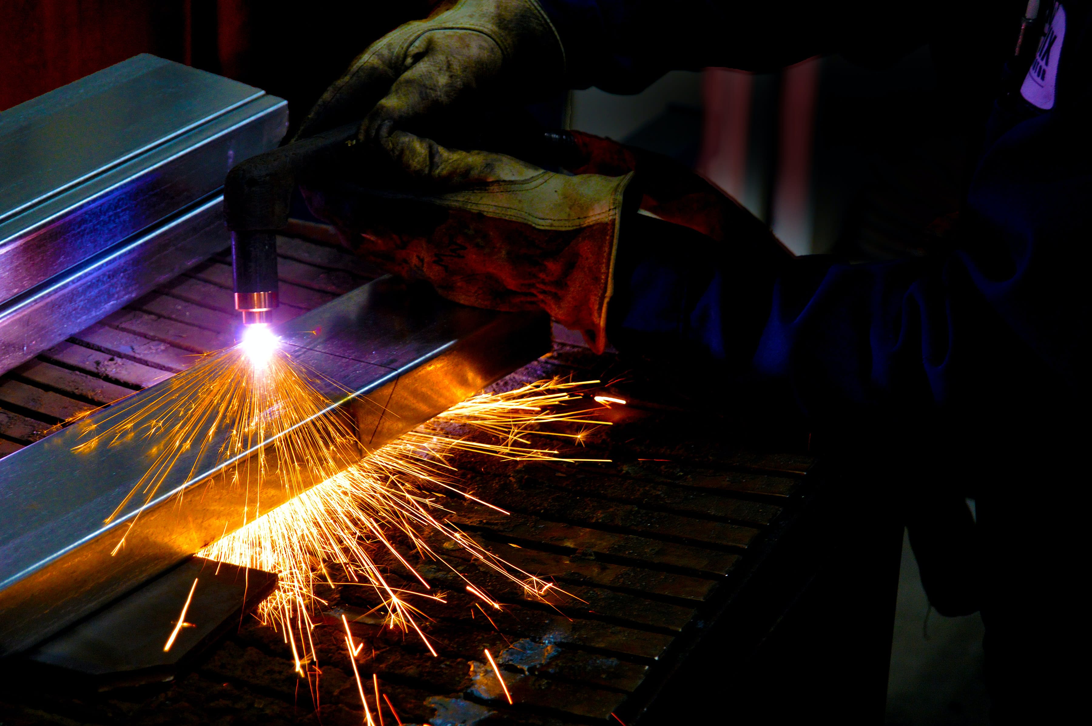 Plasma cutter in the hands of an expert. High quality work at a factory.