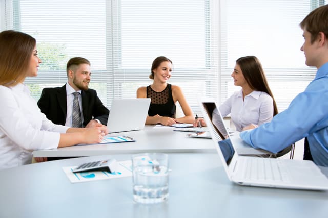 Group of happy businesspeople in a meeting at office