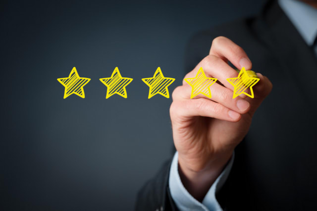 Increase rating, evaluation and classification concept. Businessman draw five yellow star to increase rating of his company.