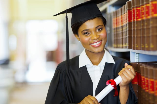 pretty female african college graduate in library