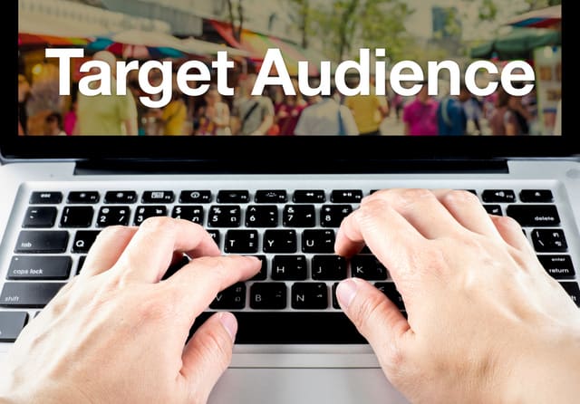 Target audience word on laptop screen with hand type on keyboard, Digital Marketing concept.