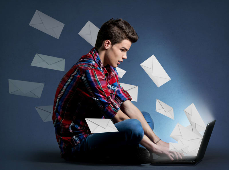 Young man receiving tons of messages on laptop