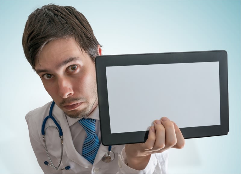 Doctor is showing blank and empty tablet for custom text.