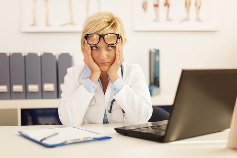 Desperate female doctor sitting at her office