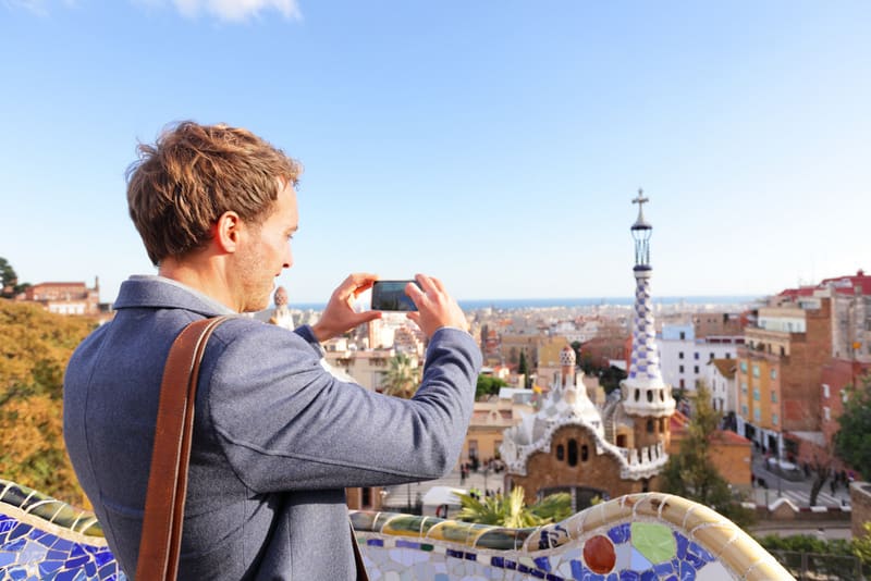 Tourist man taking photo in Park Guell, Barcelona