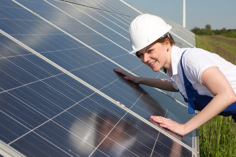 An engineer or installer inspecting solar energy panels