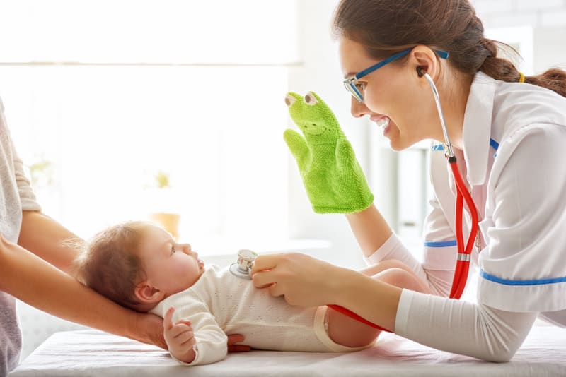doctor examining a baby in a hospital