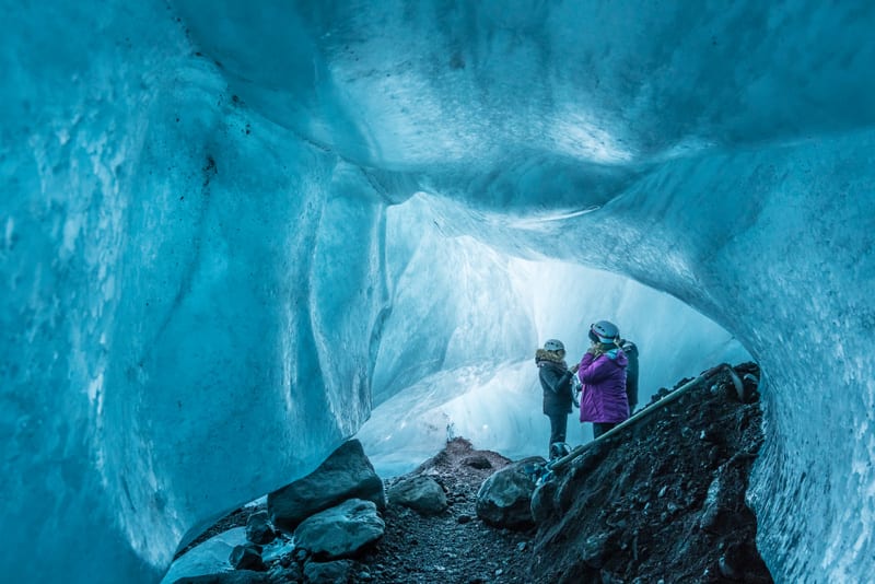 Tourists visit an ice cave under a glacier in Iceland