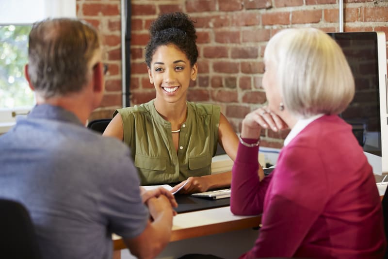 Senior Couple Meeting With Financial Advisor In Office