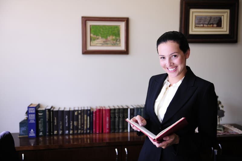 female lawyer at office reading a book