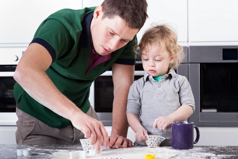 Father baking cookies with son