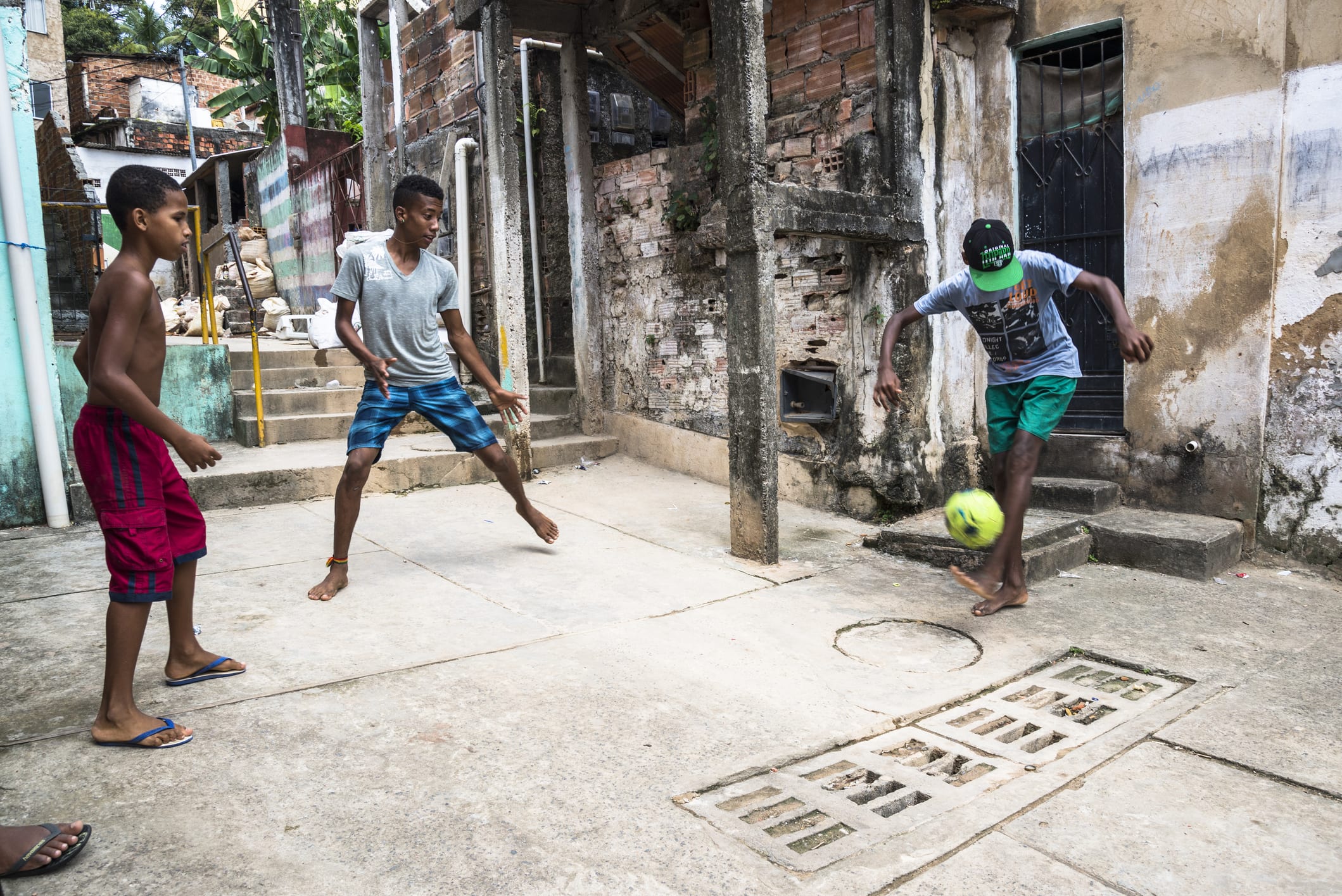 Boys playing football in the poor neighbourhoood, Salvador, Bahia, Brazil