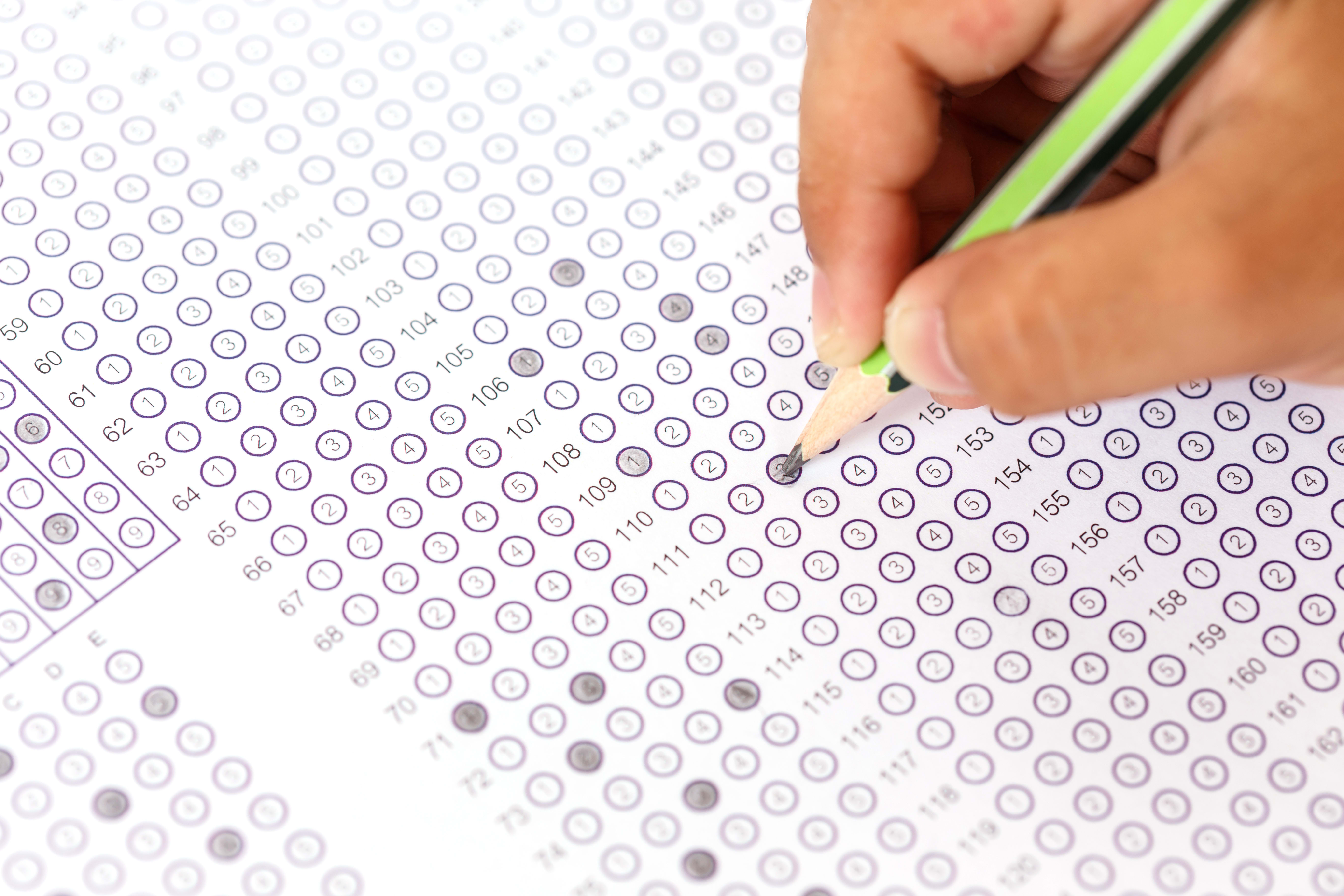 Close up hand with pencil on answer sheet