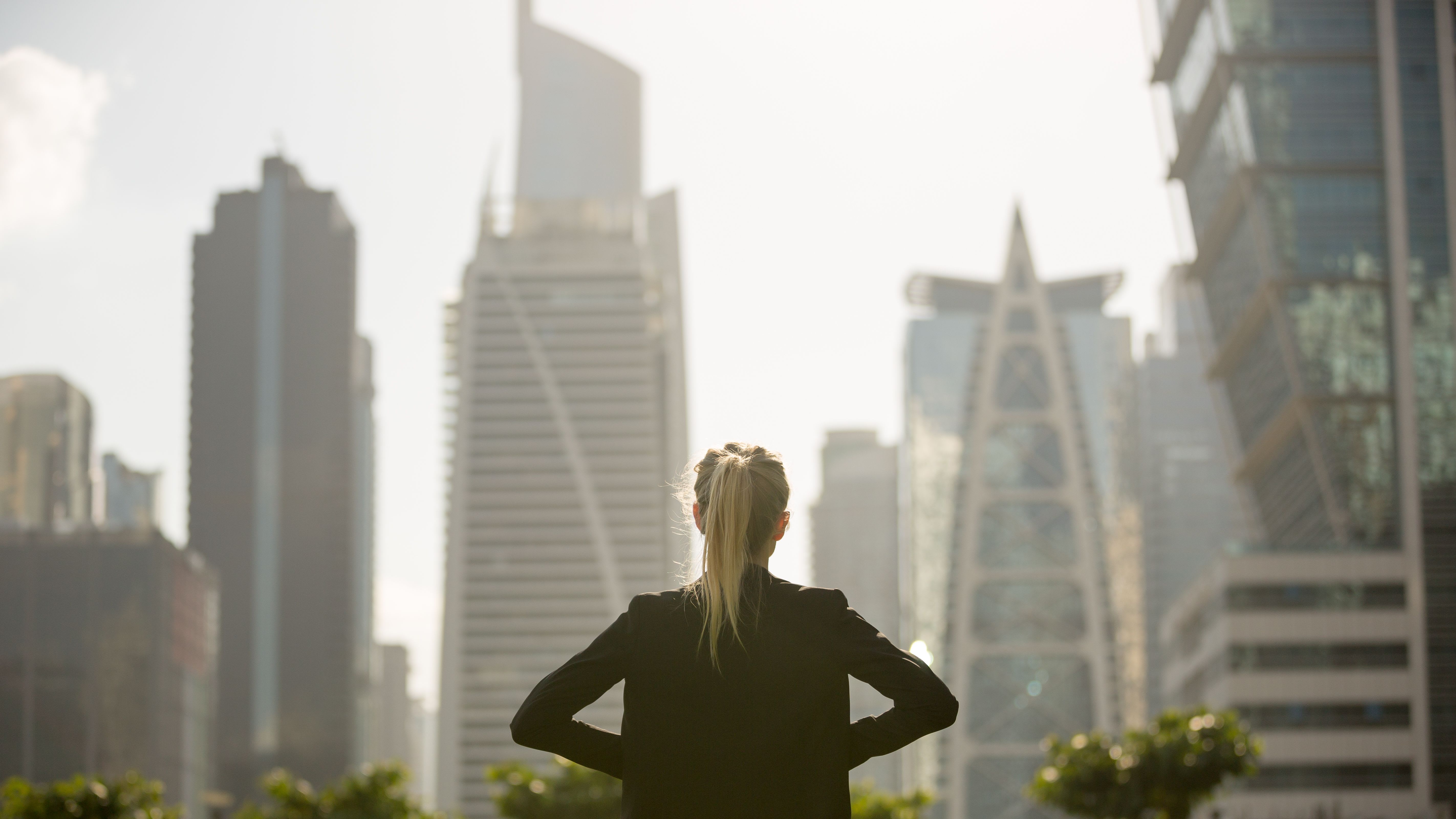 Lawyer standing strong looking at the city high-rises view