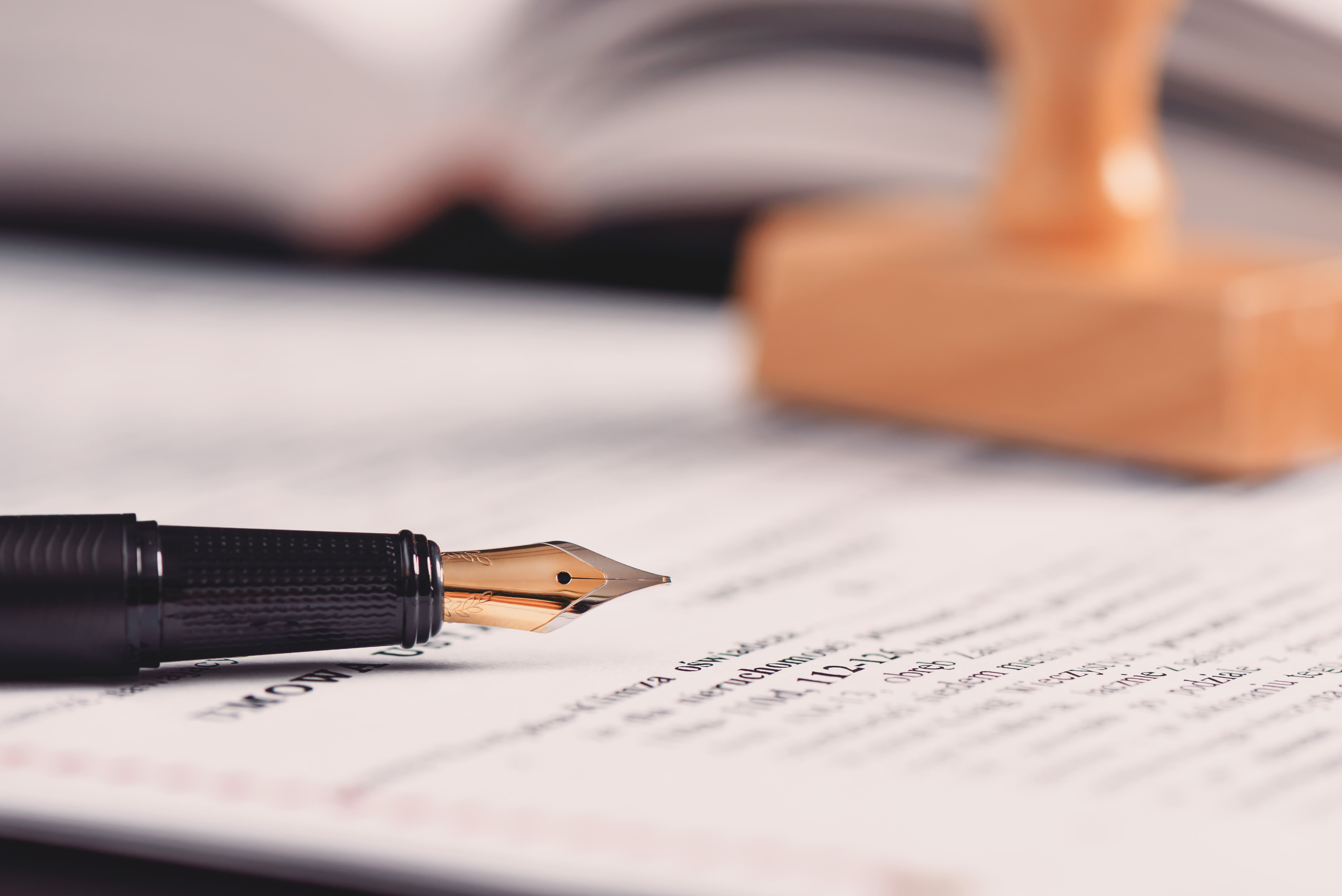 Fountain pen and legal document on desk