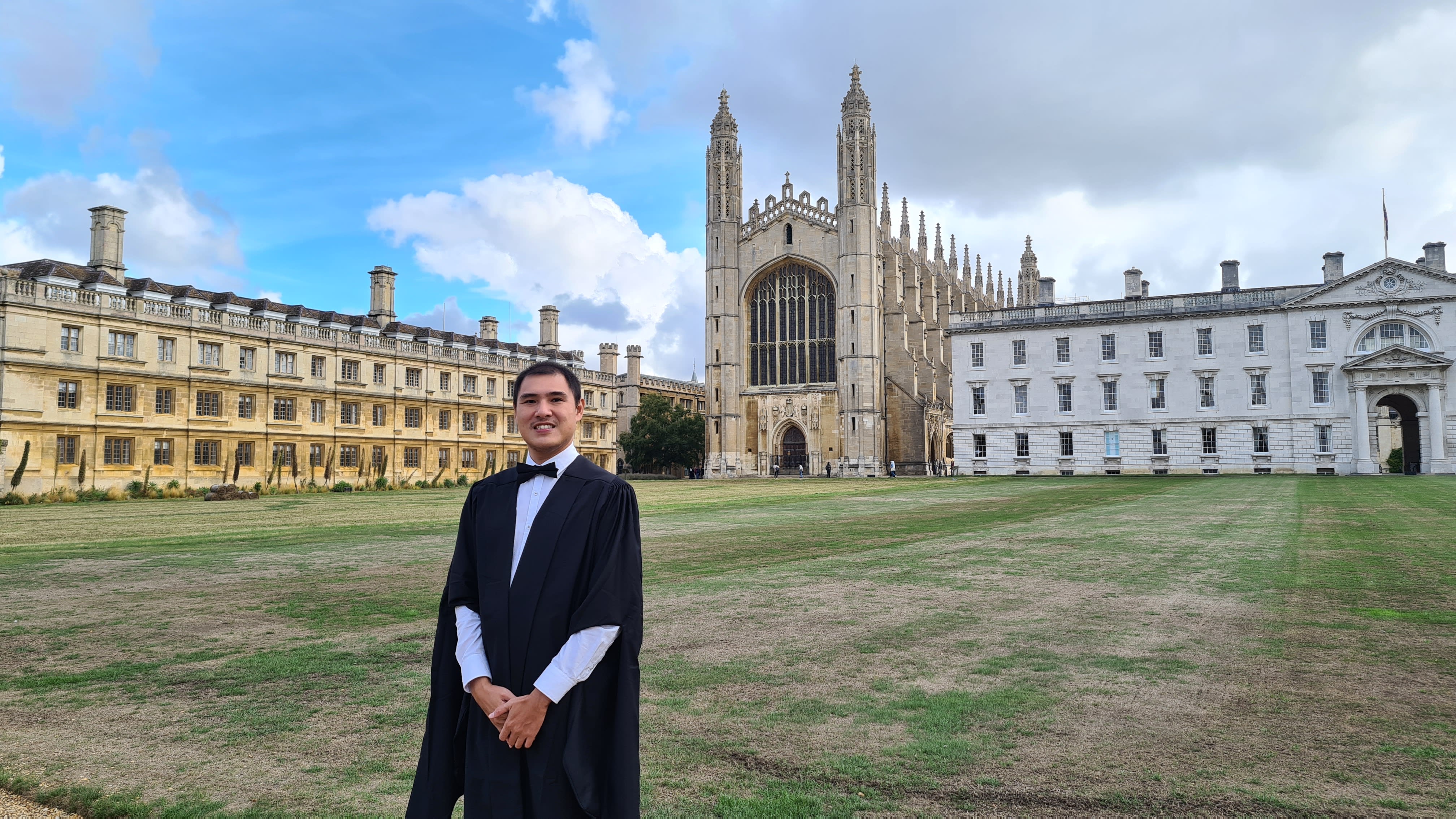 Leo Nyein Zaw Ko standing in university robes outside of the University of Cambridge