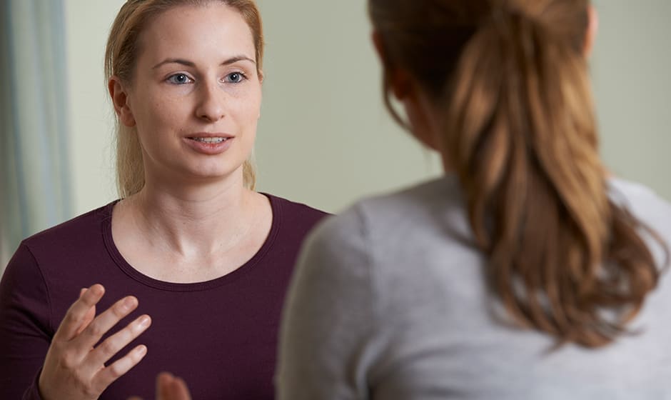 A social worker discusses with a client