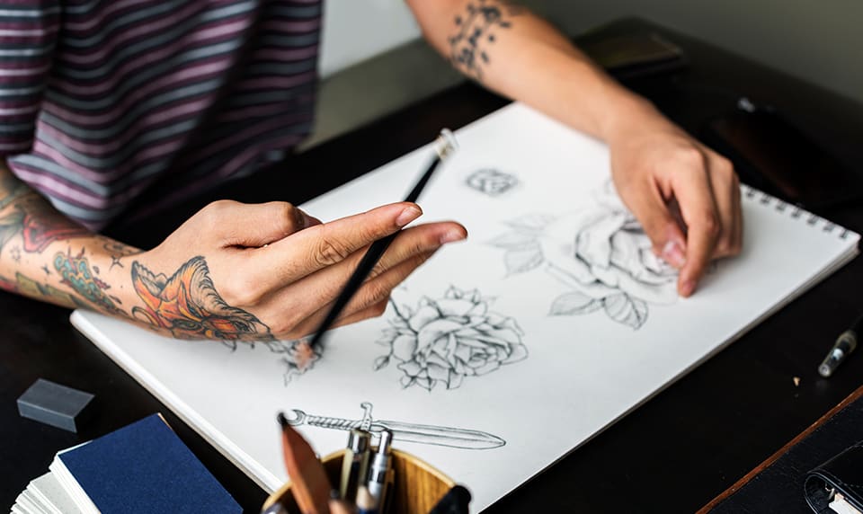 An art student draws at their desk