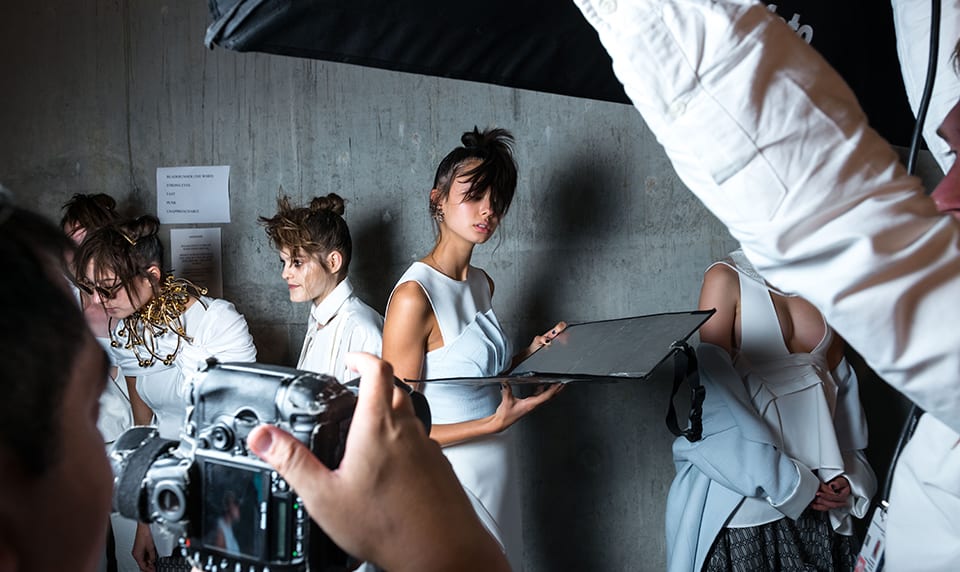 Models prepare for a photoshoot