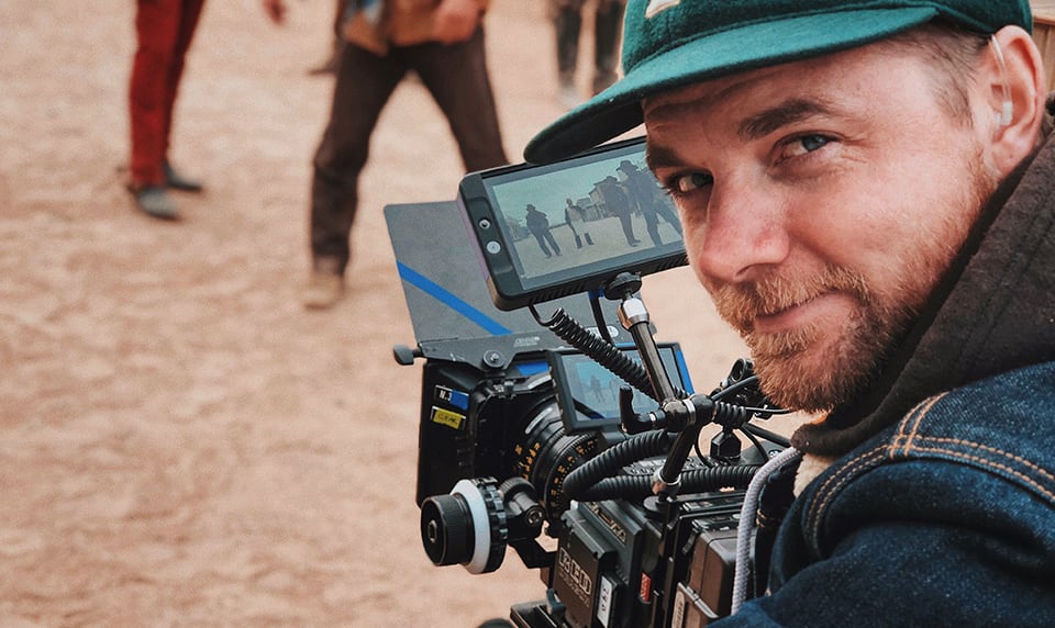 A camera operator films a Western movie