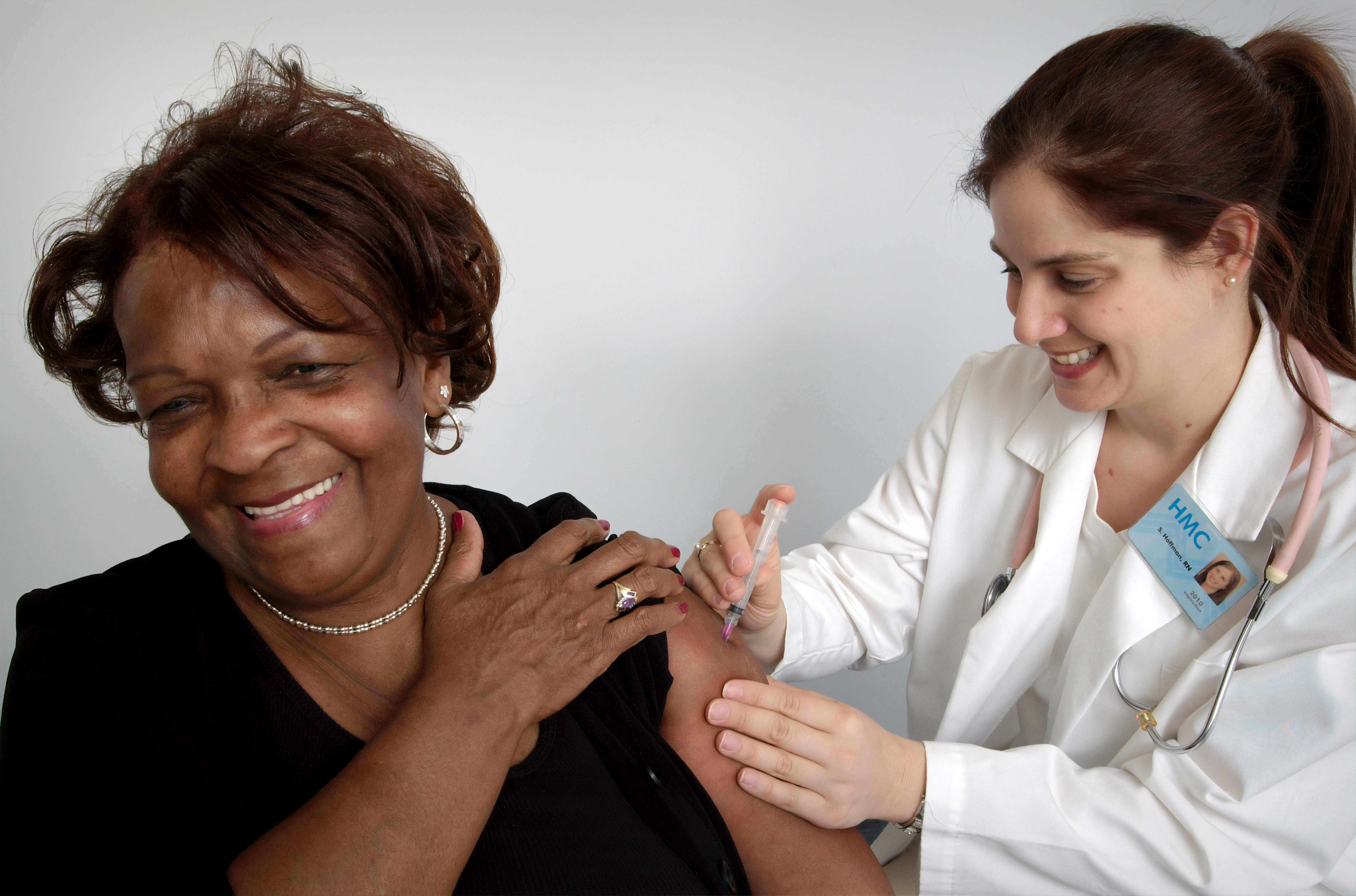 Depicted here, in this 2006 image was a middle-aged woman, who was in the process of receiving an intramuscular injection from a qualified nurse. The nurse had chosen the woman’s left shoulder muscle as the injection site, and was using her left hand to stabilize the area.