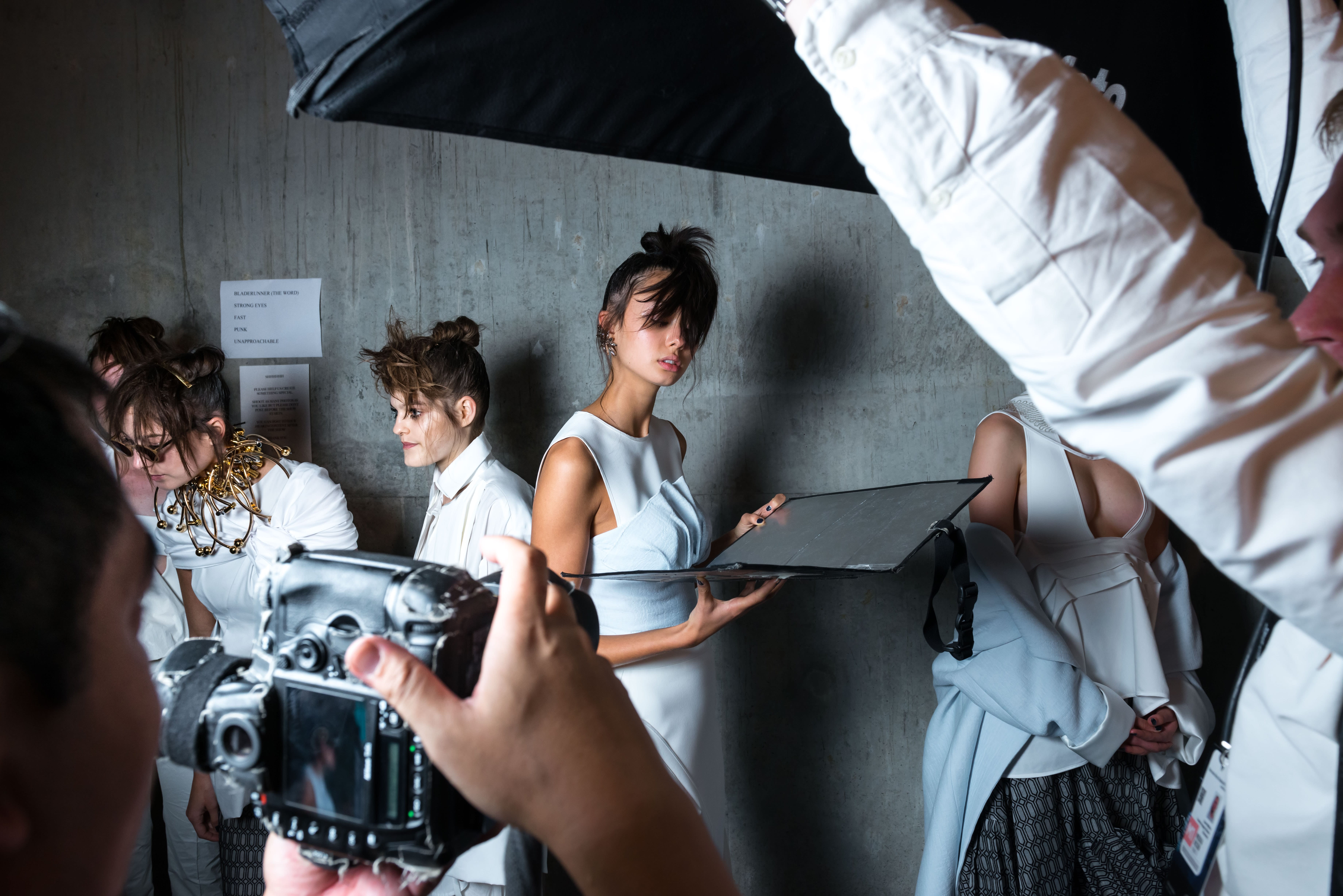 A model poses for photographers backstage at Mercedes-Benz Fashion Week.