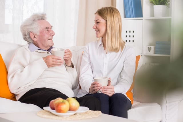 Photo of elderly man and young volunteer in nurisng home
