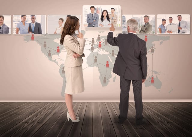 Business people selecting digital interface together showing coworkers