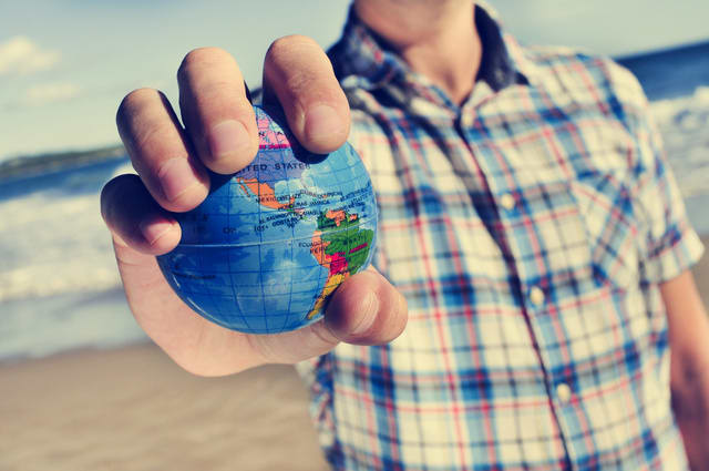 young man with a world globe in his hand
